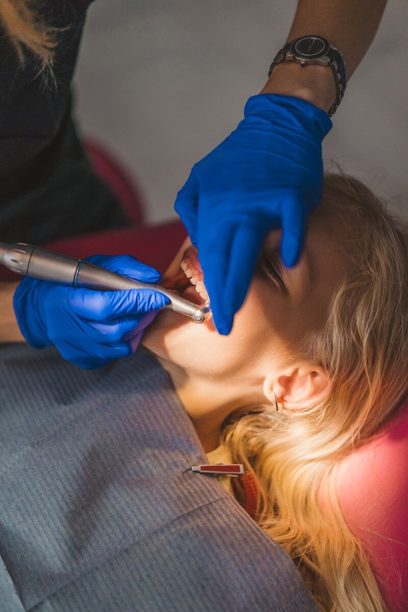 partial-view-of-dentist-in-latex-gloves-treating-l-2024-11-13-02-35-05-utc